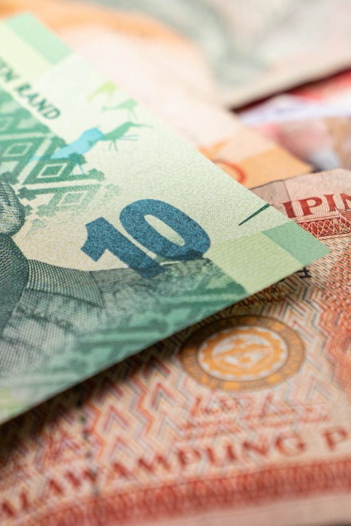 A detailed image featuring South African rand and Philippine pesos, highlighting cultural diversity in currency.